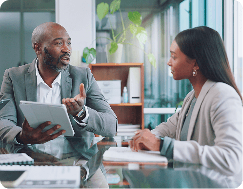 Professional tax planner advising client in modern office setting, discussing financial strategies and personalized tax planning services.